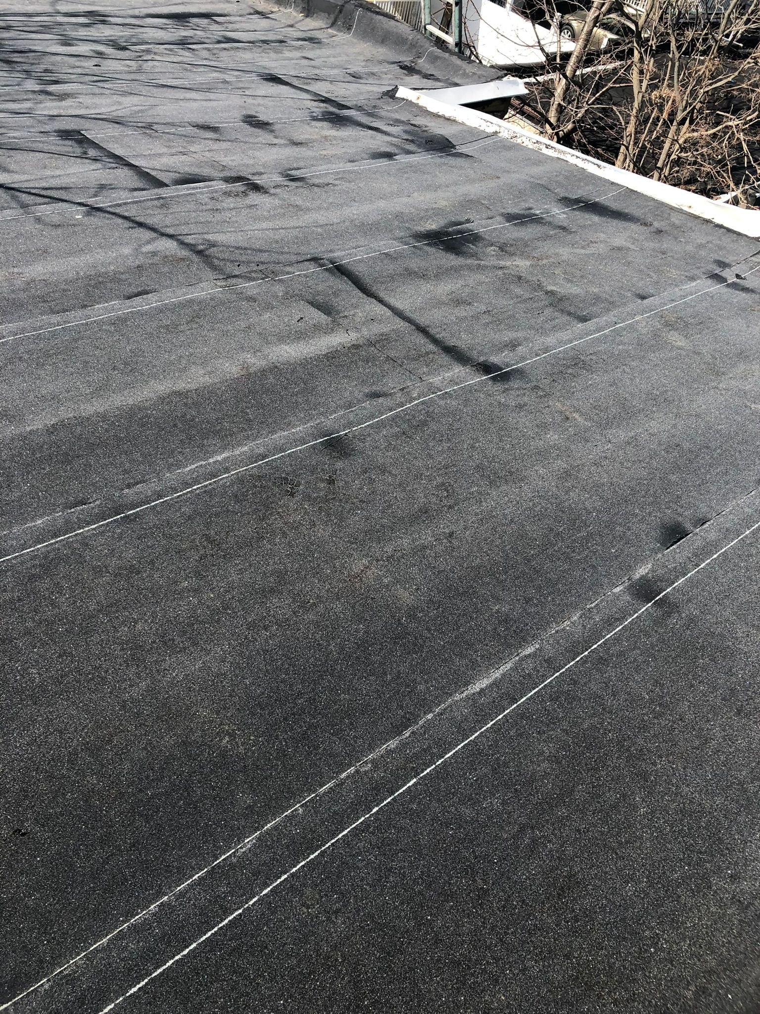Close-up view of a flat roof surface after installation, showing layers of roofing membrane.Torch Down, EPDM & TPO Roofing