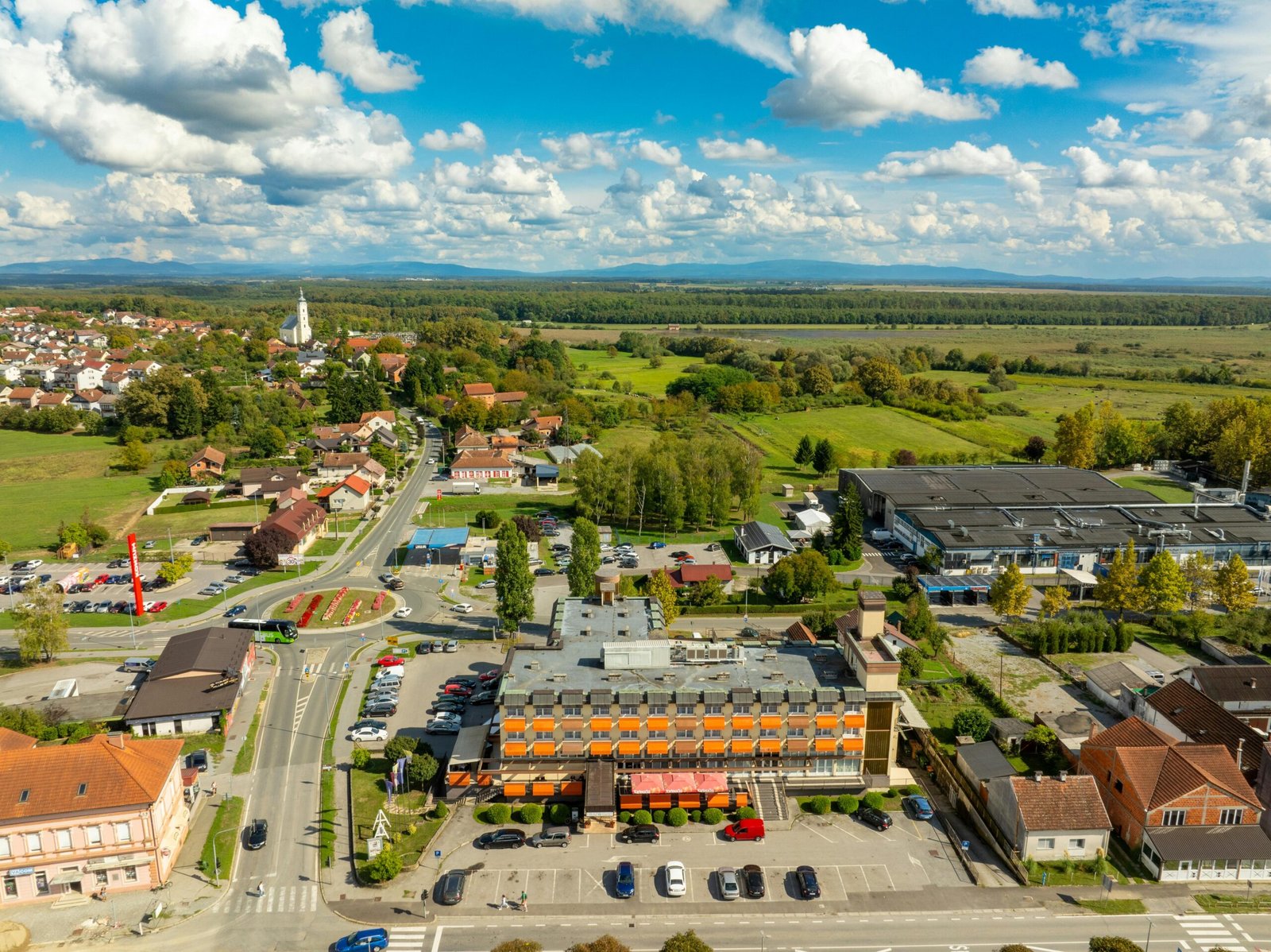 Aerial view of a commercial building with flat roofing system in a busy urban area.